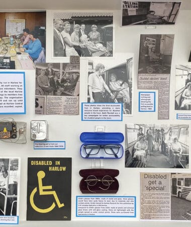 A photograph depicting a wall collage full of images, news articles, and glasses of the disability exhibition at the Harlow museum.